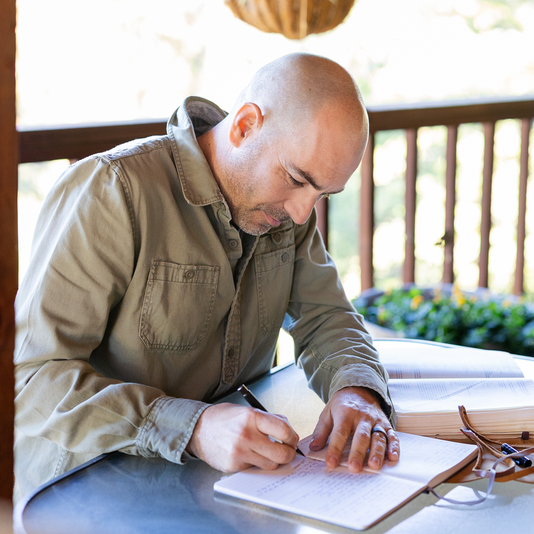 a man tracking his goals on a to do check list