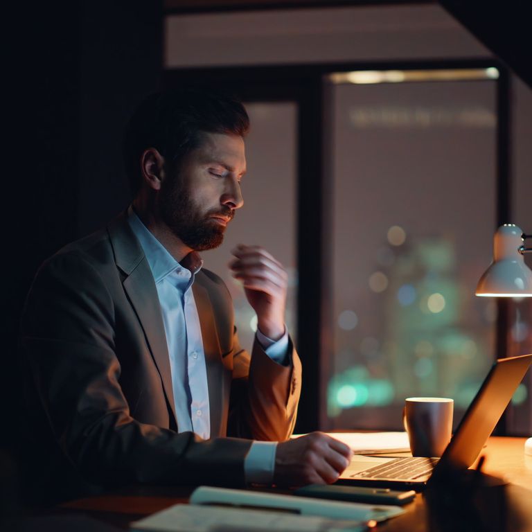 Business owner talking with a customer across a table, guiding them with calm confidence
