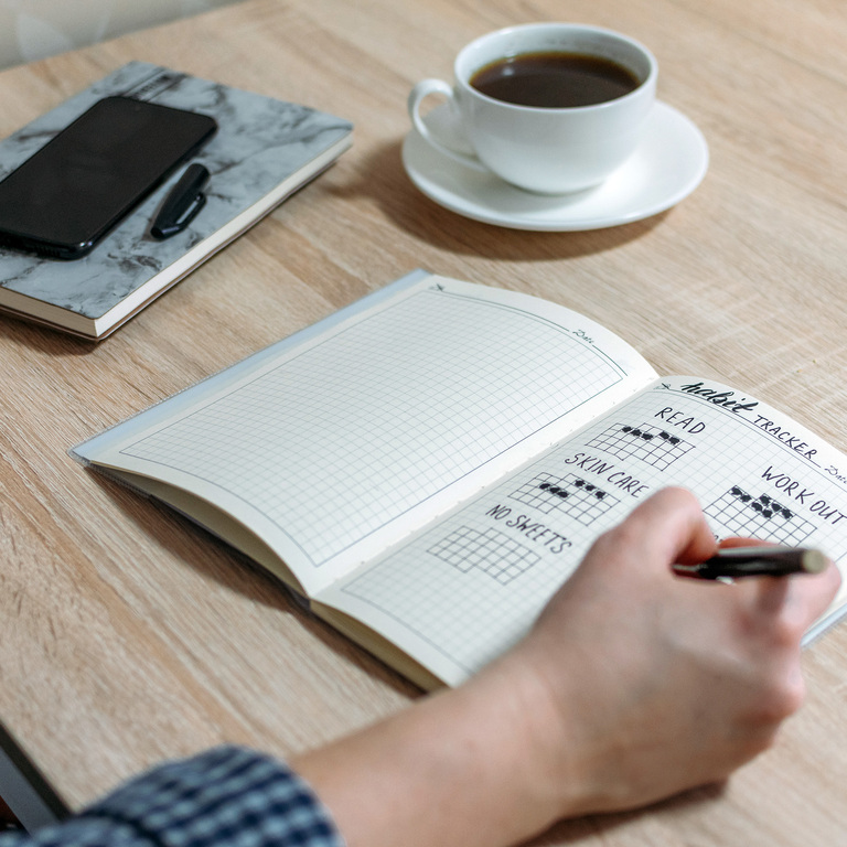 a man tracking his goals on a to do check list