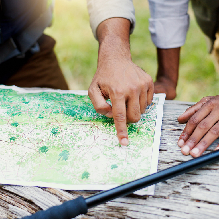 A farmer walking the edge of his field at sunrise, inspecting the soil and crops
