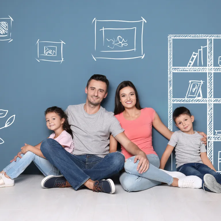 a family sitting in a living room with sketches of the future around them
