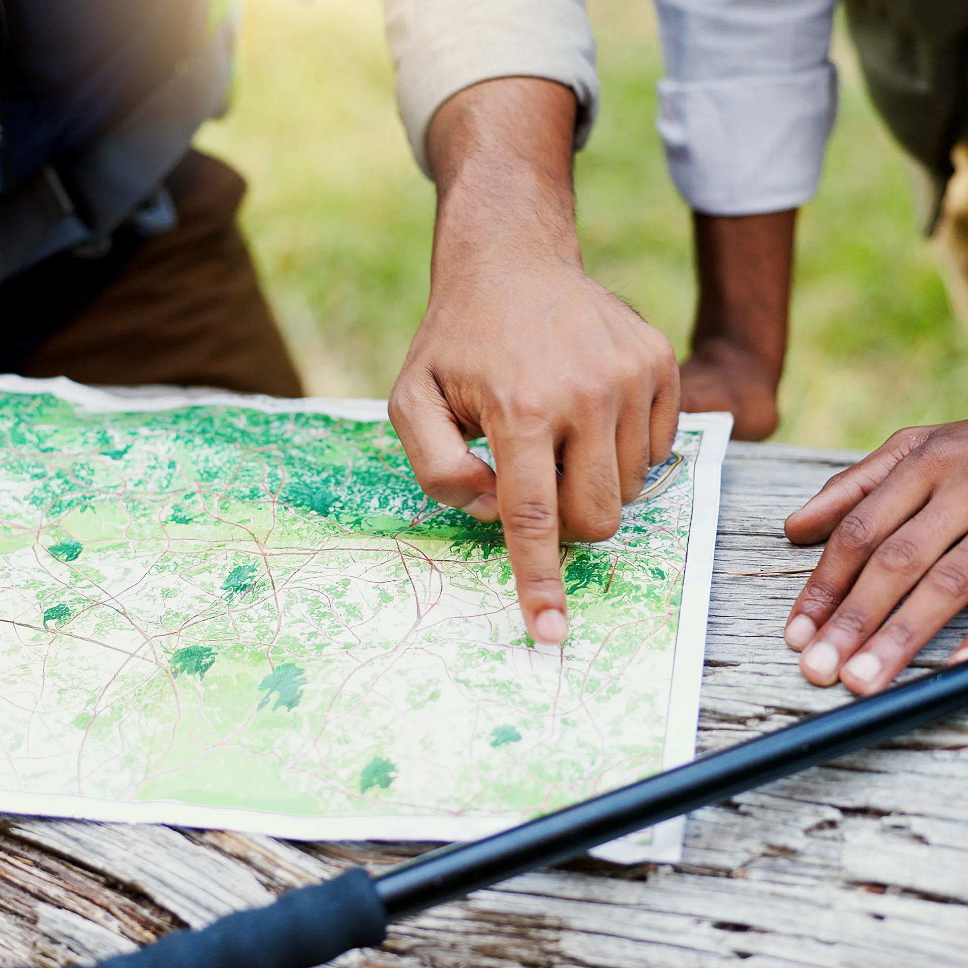 business owner sitting at a desk, reflecting on a long road to growth while reviewing notes and client work