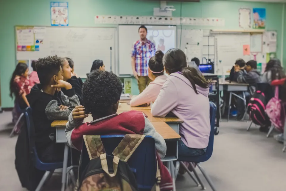 students sitting on chairs in a classroom