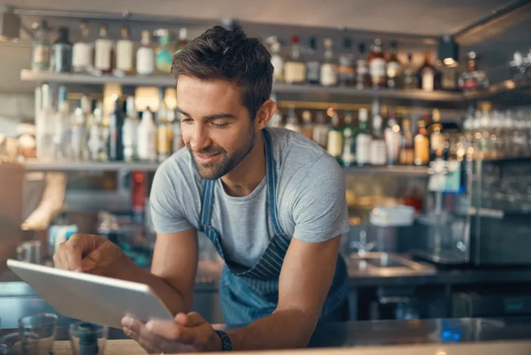 A business owner reviewing financial documents, focused on consistent growth and profitability.