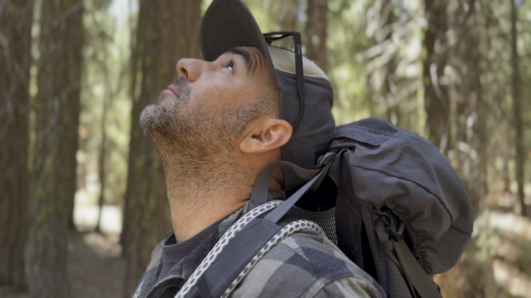 A close-up of a man’s boot stepping onto a rocky mountain trail, symbolizing the start of an intentional journey.