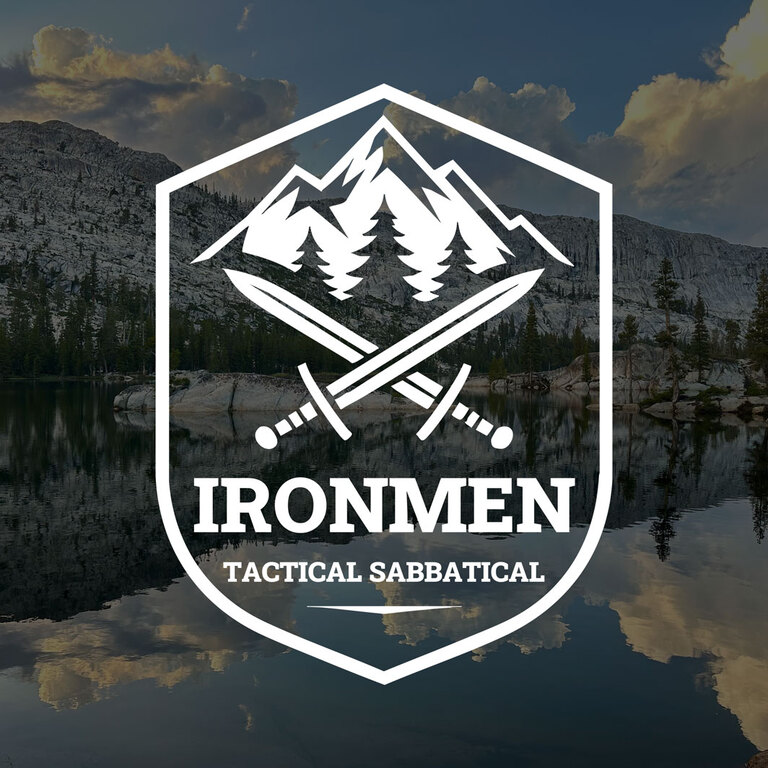 An emblem with two swords crossed with a lake in the background