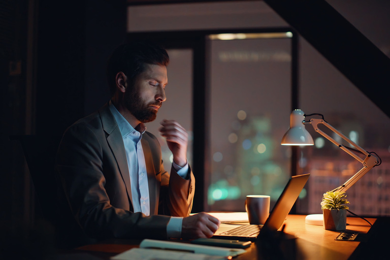 a weary businessman working late in to the night