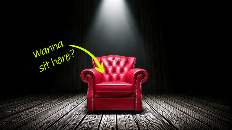 a red leather chair in the spotlight a dark room - volunteer to sit in the hot seat