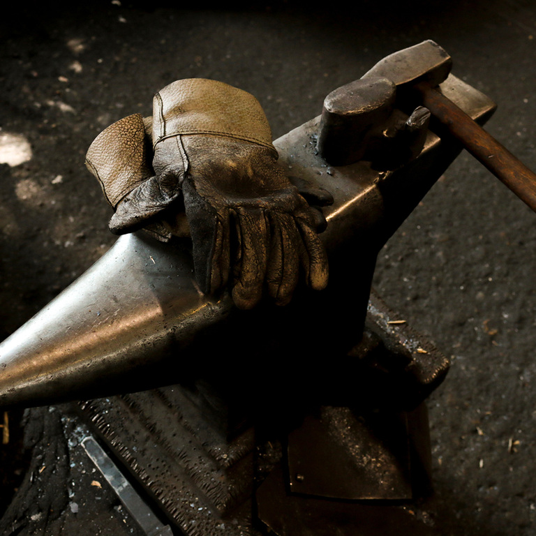 tools organized on top of an anvil ready for work