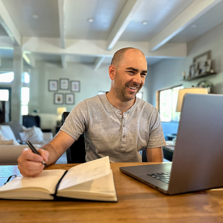 A business owner reviewing financial documents, focused on consistent growth and profitability.